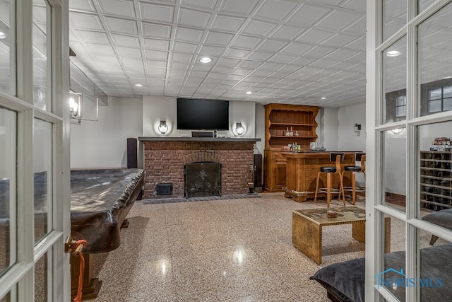 living room featuring bar area and a fireplace