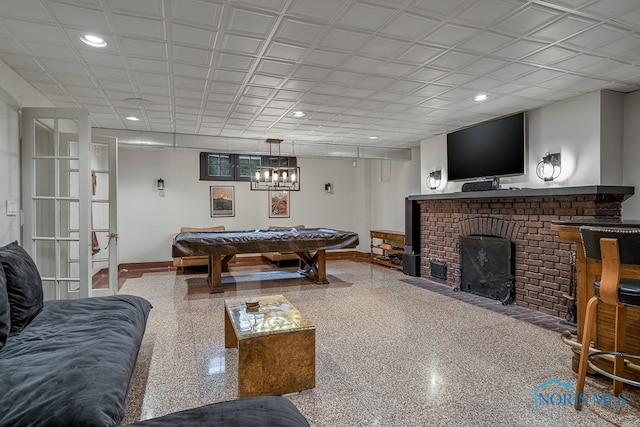 playroom with billiards and a fireplace