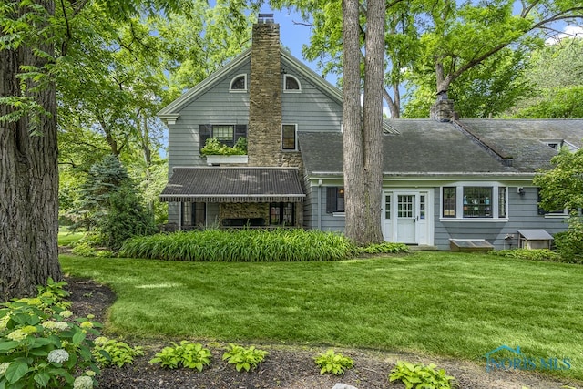 rear view of house with a yard