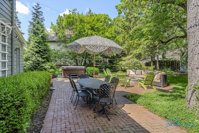 view of patio / terrace featuring a hot tub and an outdoor hangout area