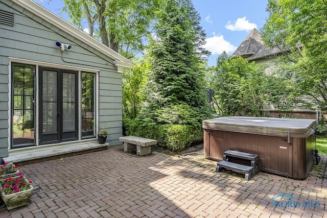 view of patio / terrace with a hot tub