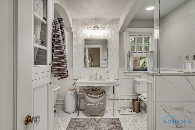 bathroom with tile patterned flooring, sink, and toilet