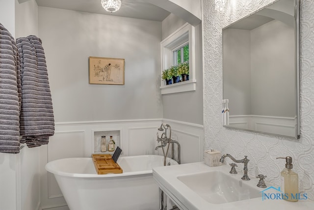 bathroom with a bathing tub, sink, and backsplash