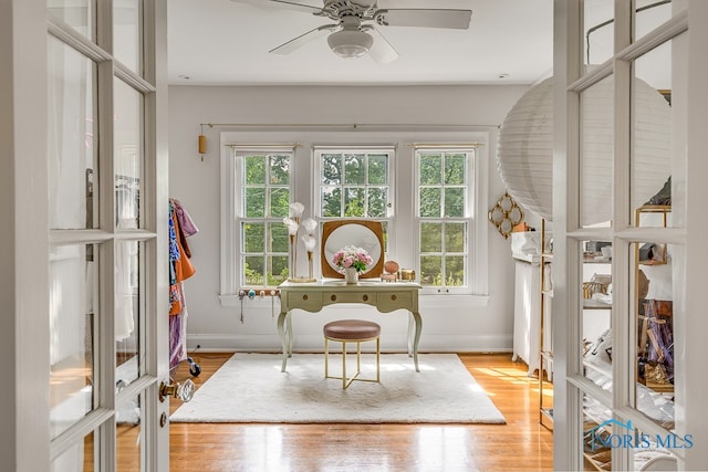 sunroom / solarium featuring a wealth of natural light and ceiling fan