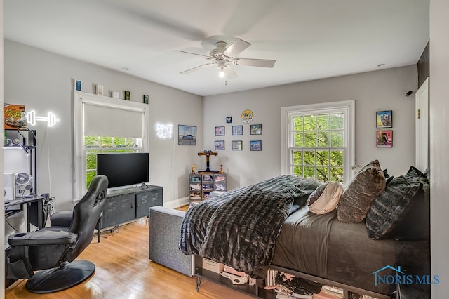 bedroom with light hardwood / wood-style floors and ceiling fan