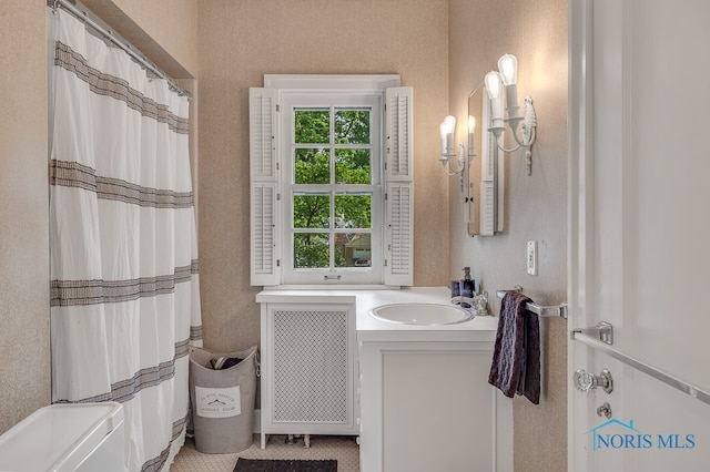 bathroom with a shower with curtain, vanity, and radiator heating unit