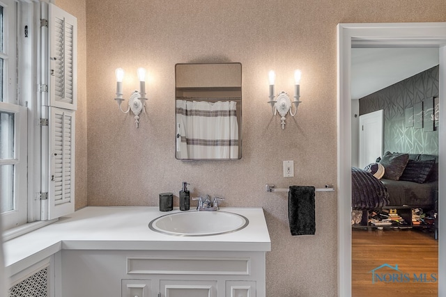 bathroom featuring hardwood / wood-style flooring and vanity