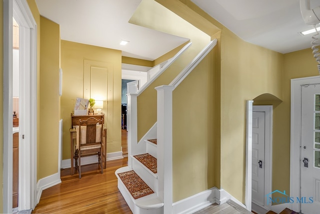 staircase featuring hardwood / wood-style flooring