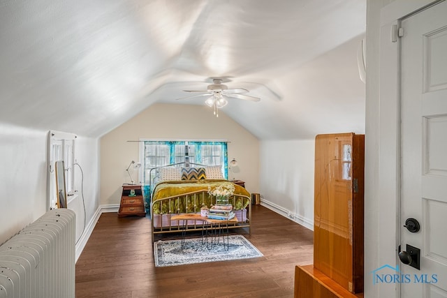 bedroom featuring dark hardwood / wood-style floors, ceiling fan, and vaulted ceiling