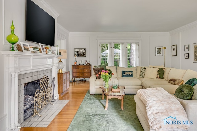 living room with wood-type flooring and ornamental molding