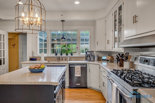 kitchen featuring white cabinetry, light hardwood / wood-style flooring, appliances with stainless steel finishes, and a center island