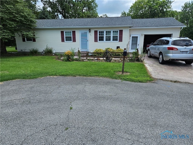 single story home with a garage and a front yard