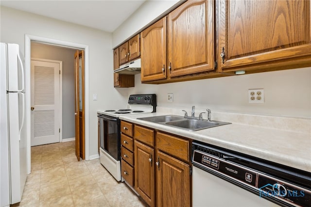 kitchen featuring white appliances and sink