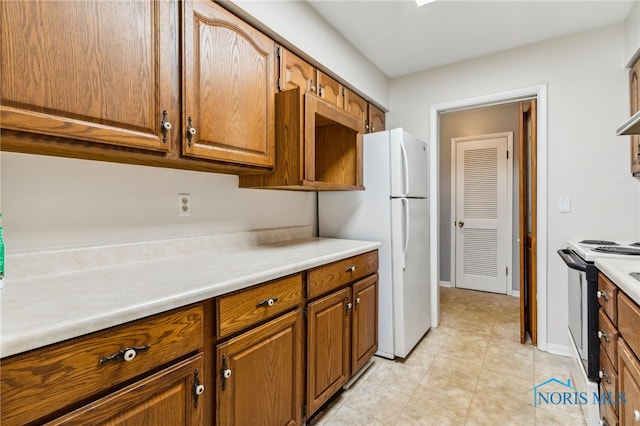 kitchen with light tile patterned floors and white appliances