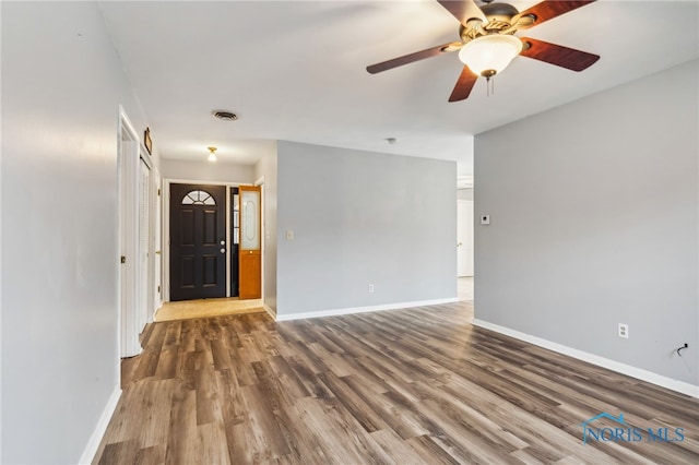 interior space featuring dark wood-type flooring and ceiling fan