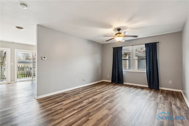 unfurnished room with dark hardwood / wood-style flooring and ceiling fan