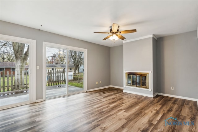 unfurnished living room featuring hardwood / wood-style flooring and ceiling fan