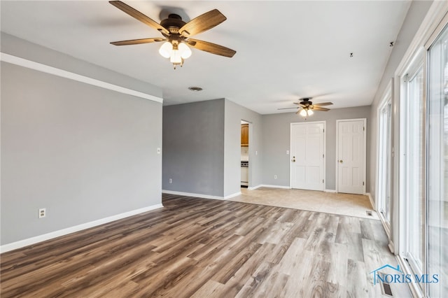 unfurnished living room with hardwood / wood-style flooring and ceiling fan