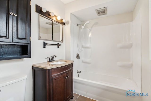 full bathroom featuring vanity, tile patterned flooring, toilet, and bathtub / shower combination