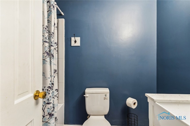 bathroom featuring toilet and shower / bathtub combination with curtain