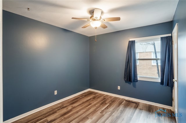 unfurnished room with hardwood / wood-style floors and ceiling fan