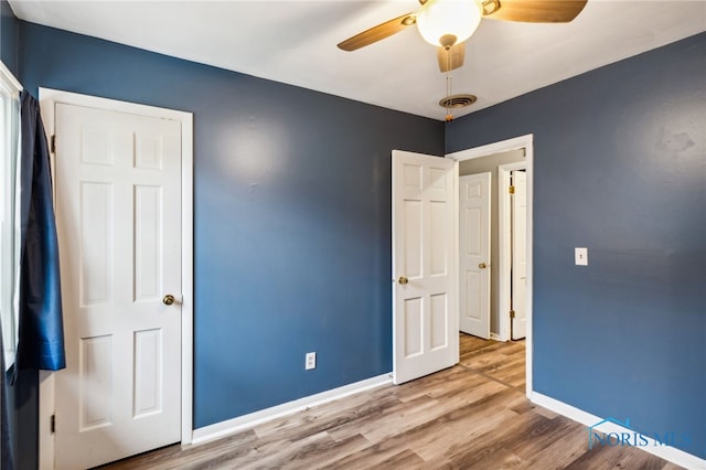 unfurnished bedroom with hardwood / wood-style flooring and ceiling fan