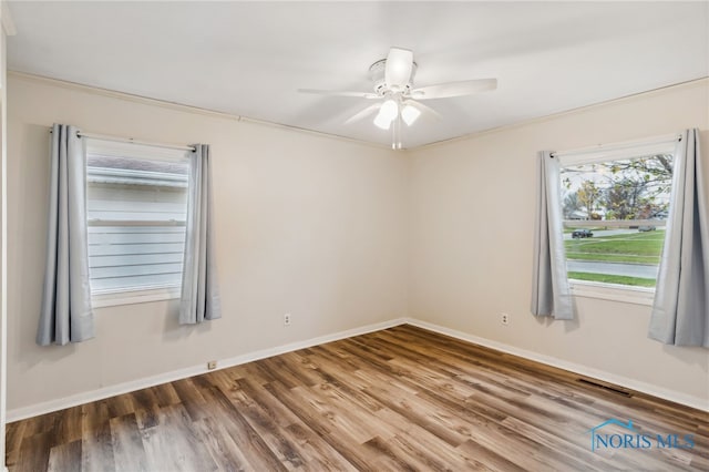 unfurnished room with crown molding, hardwood / wood-style flooring, and ceiling fan