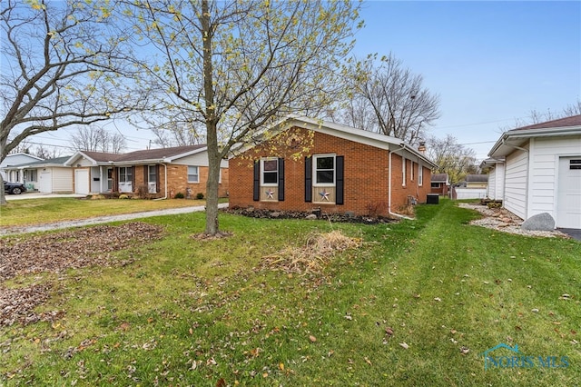 view of side of home with a lawn