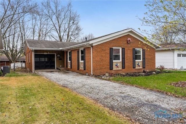 ranch-style home with a front yard and central AC