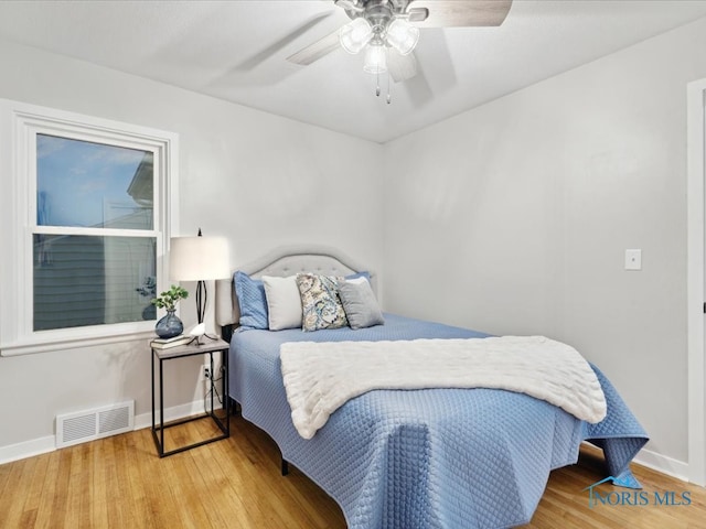 bedroom featuring hardwood / wood-style floors and ceiling fan