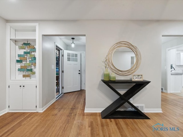 entryway with light hardwood / wood-style floors