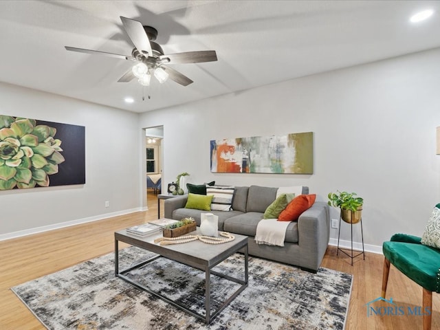 living room with hardwood / wood-style flooring and ceiling fan