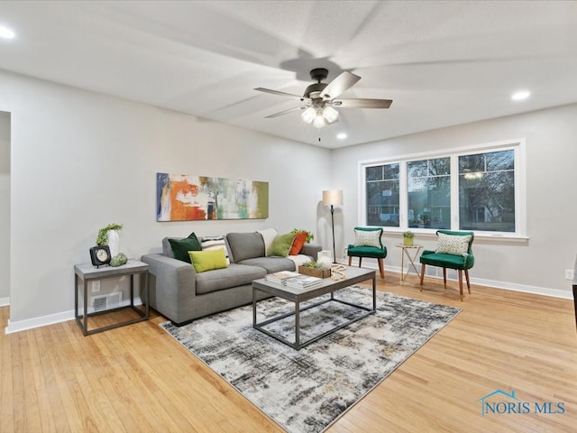 living room with ceiling fan and wood-type flooring