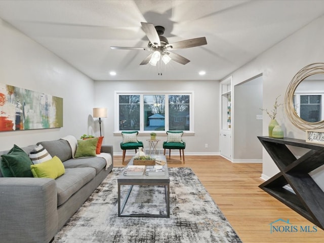 living room featuring hardwood / wood-style flooring and ceiling fan