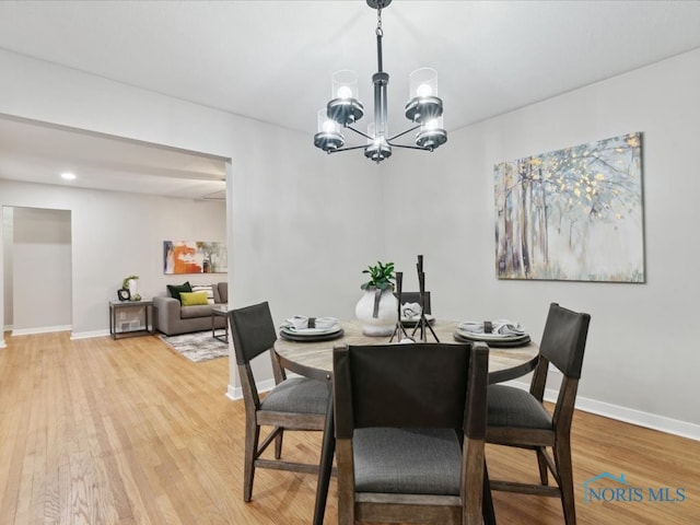 dining space featuring a chandelier and hardwood / wood-style floors