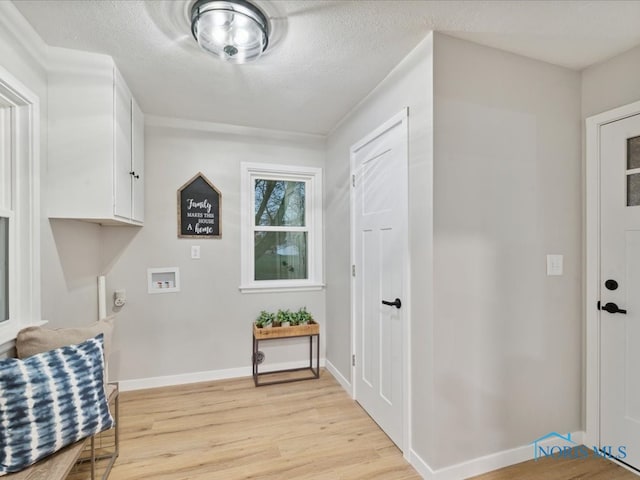 interior space featuring a textured ceiling and light hardwood / wood-style flooring