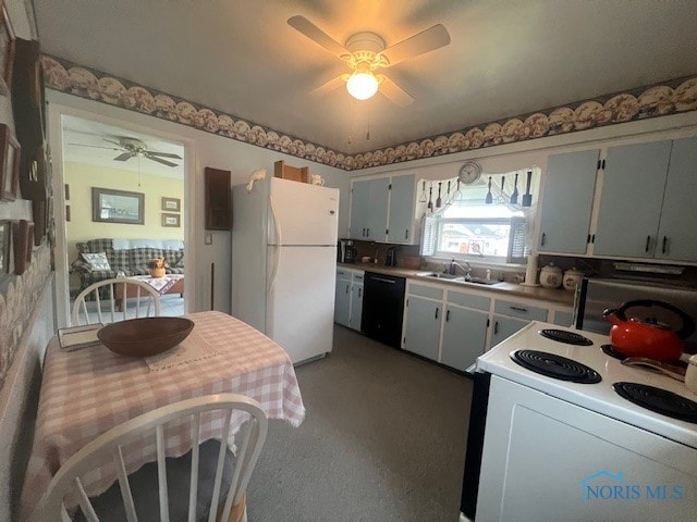 kitchen with carpet flooring, ceiling fan, sink, and white appliances