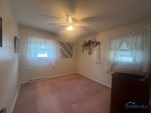 carpeted spare room featuring ceiling fan