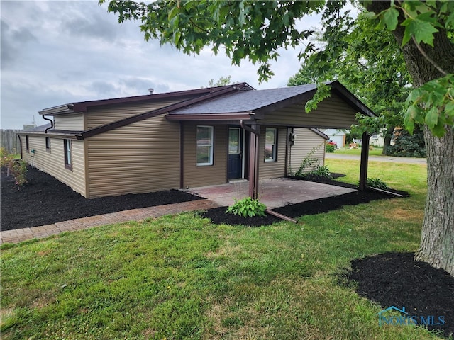 back of property with a lawn and a patio area