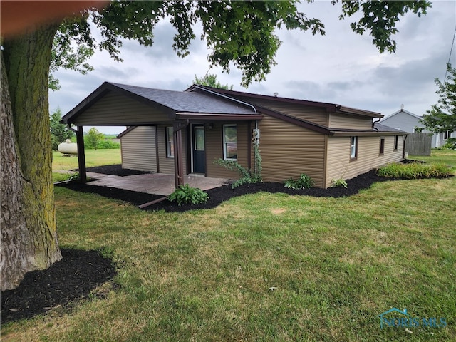 view of front of house with a front yard and a patio area