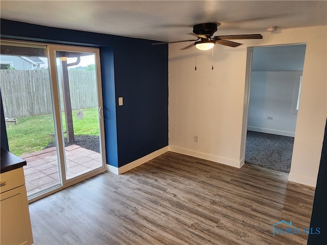 spare room with hardwood / wood-style flooring and ceiling fan