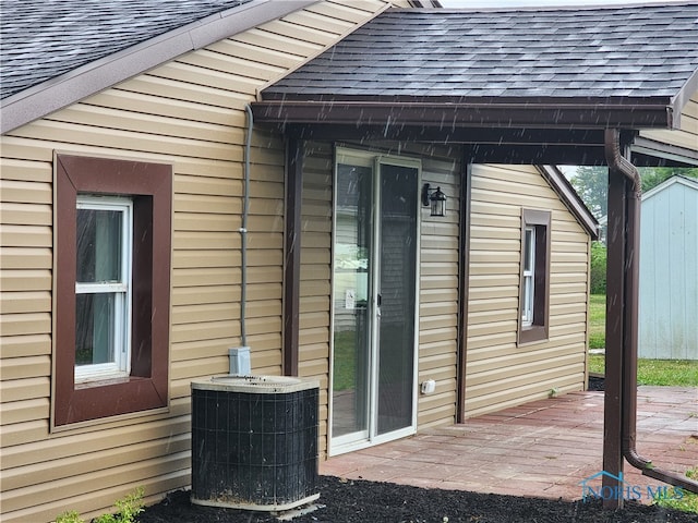 view of home's exterior with central AC and a wooden deck