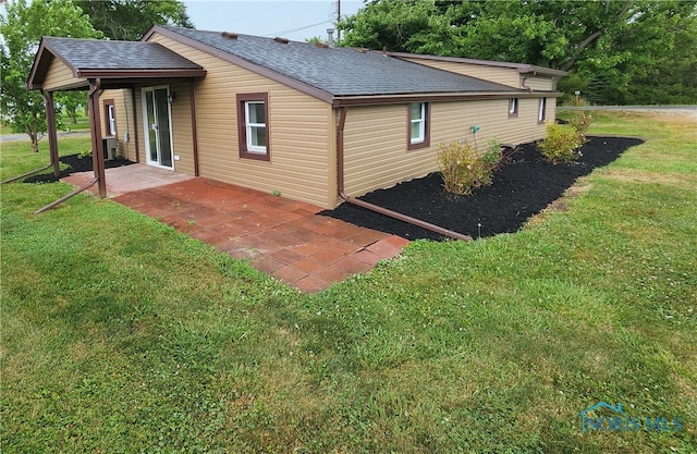 view of home's exterior with a patio and a yard