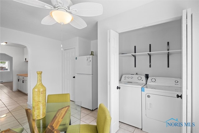 laundry area with washing machine and dryer, ceiling fan, and light tile patterned floors