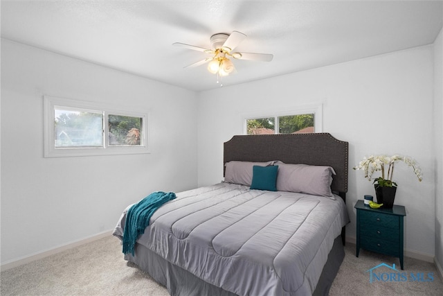 bedroom with ceiling fan and light carpet