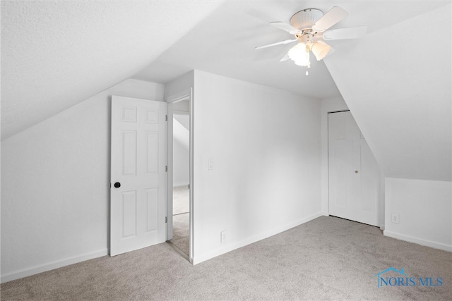 bonus room with light carpet, ceiling fan, and vaulted ceiling