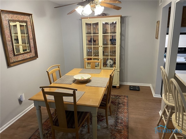 dining room with dark hardwood / wood-style flooring and ceiling fan