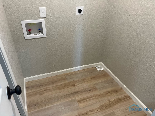 washroom with hookup for a washing machine, hardwood / wood-style flooring, and electric dryer hookup