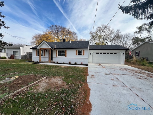 single story home with a front yard and a garage