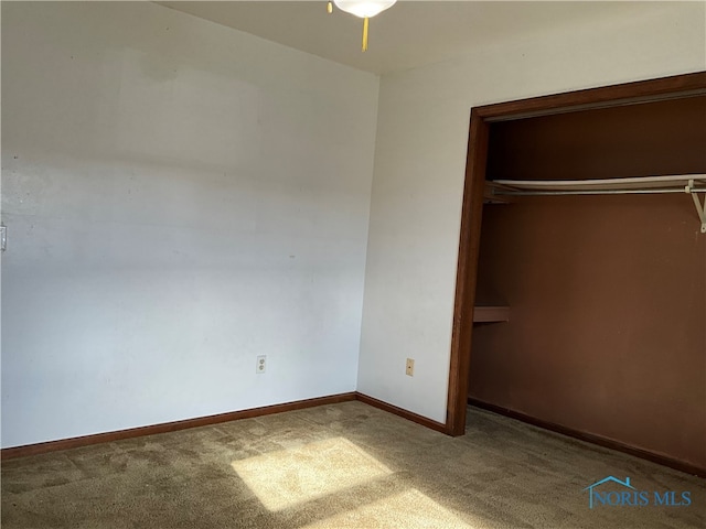 unfurnished bedroom with a closet and carpet floors